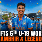 Vaibhav Suryavanshi raising his bat after scoring a century in the U-19 World Cup Final, with the scoreboard showing India's massive total.