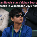 Teenage Indian cricketer Vaibhav Sooryavanshi dressed in a formal black blazer, striped tie, and sunglasses while attending the Wimbledon tennis tournament.